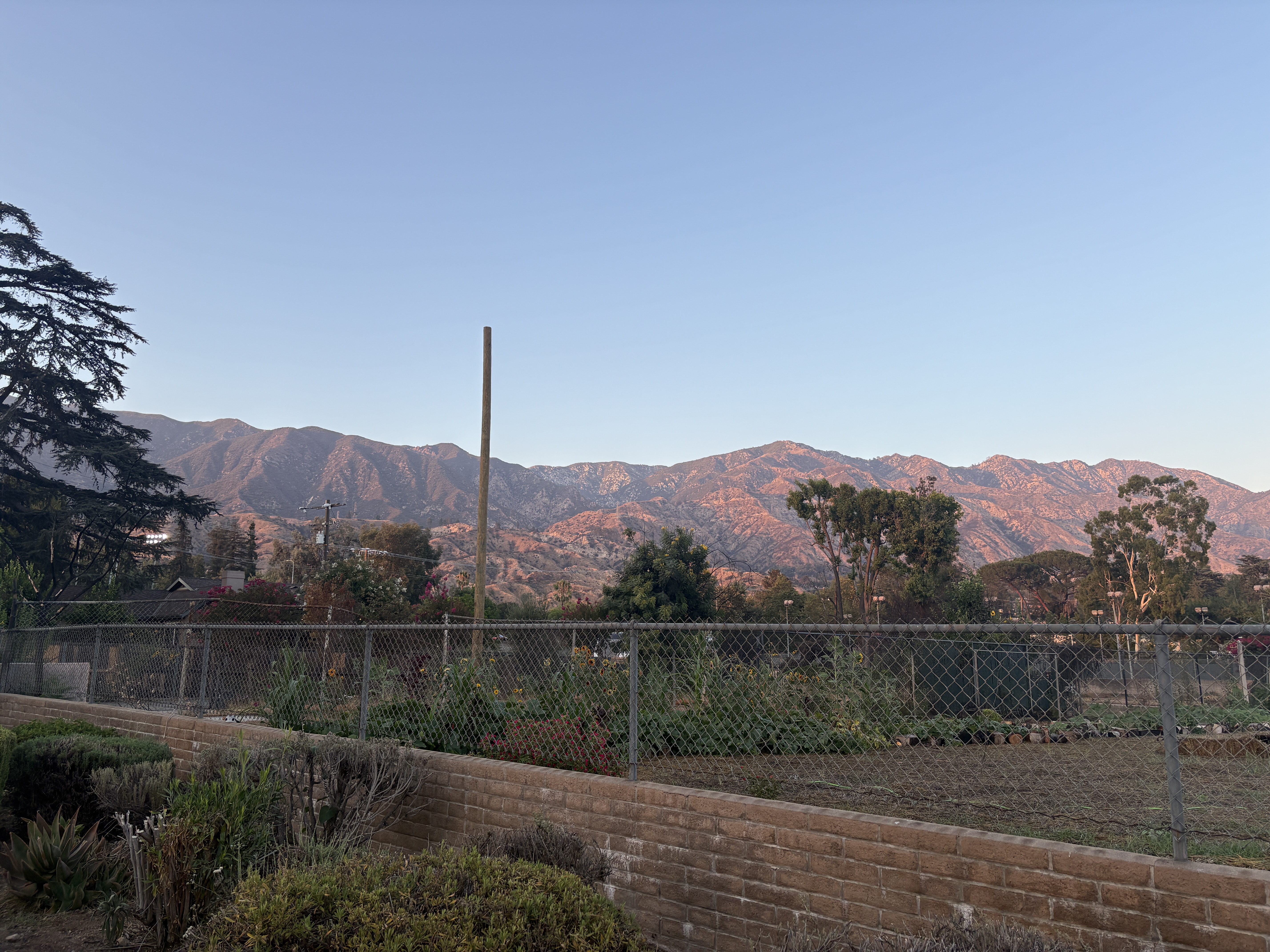 a fence line in front of hills