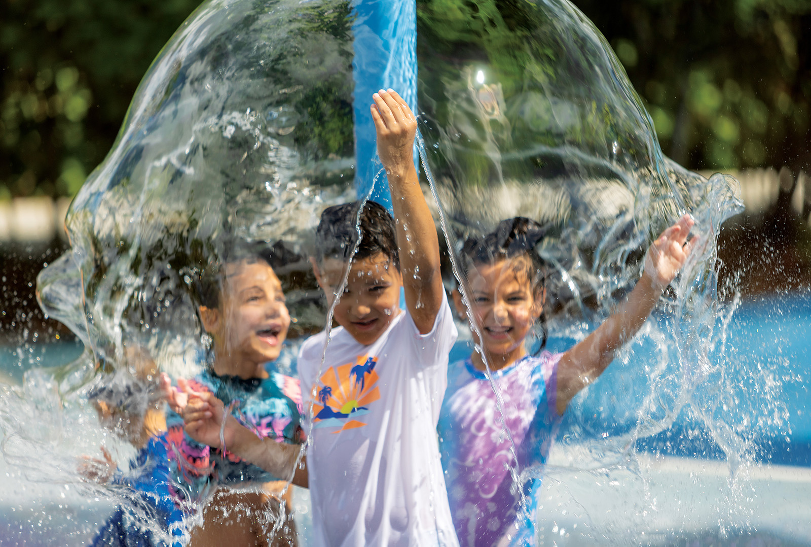 Kids cool down at an animal-themed splash pad at Zoo Miami. Mist stations also help visitors avoid overheating on sweltering days.