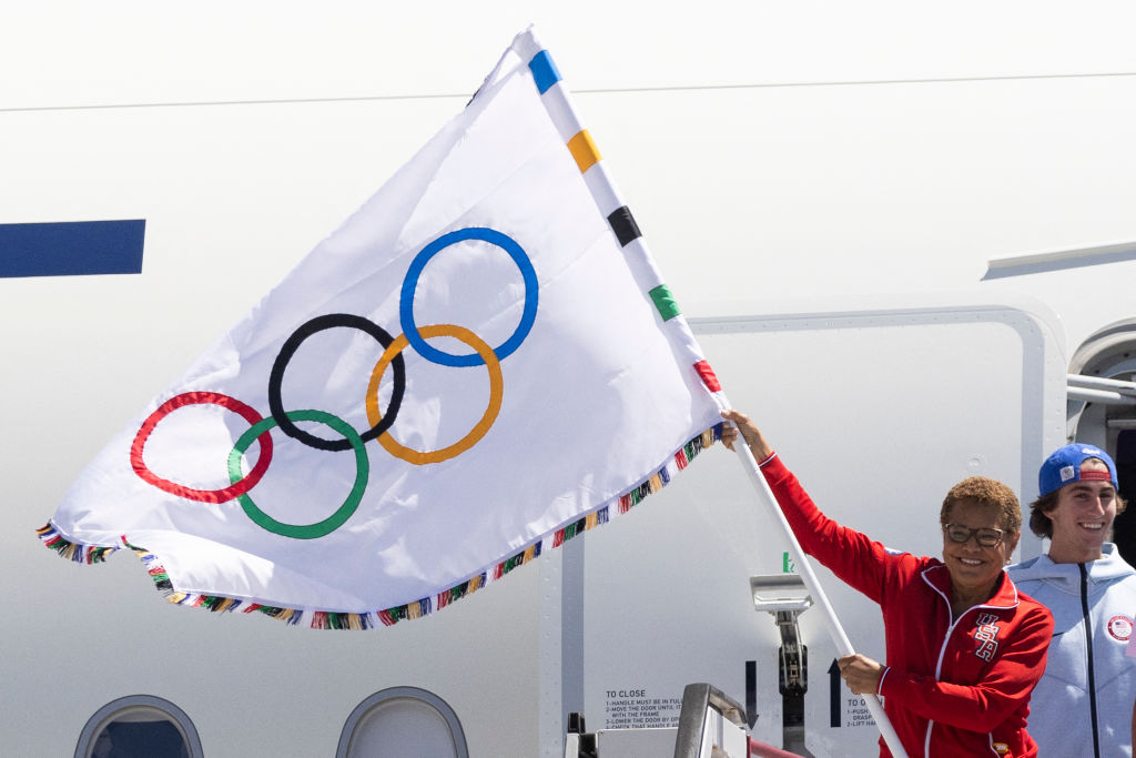 Los Angeles Mayor Karen Bass waves an Olympic flag on her return from the closing ceremony of the Paris games on August 12, 2024.