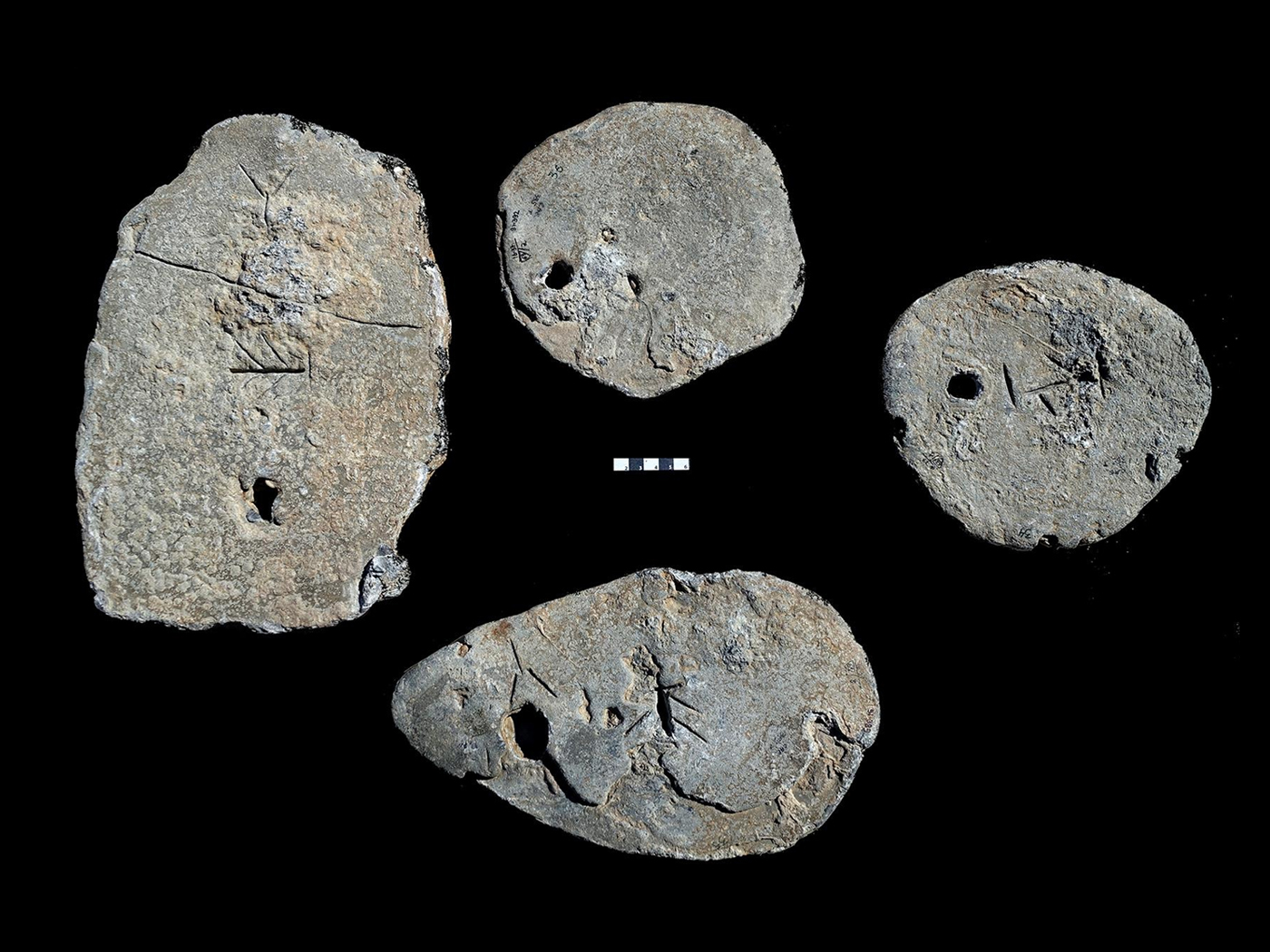 Four lead ingots found in a shipwreck off the coast of Israel feature Cypro-Minoan markings but actually originated in Sardinia. Ehud Galili / University of Haifa’s Institute for Maritime Studies
